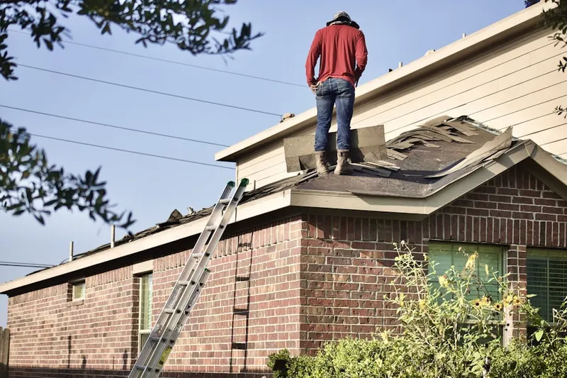 Professional roofer working on a residential roof in Spanish Hills